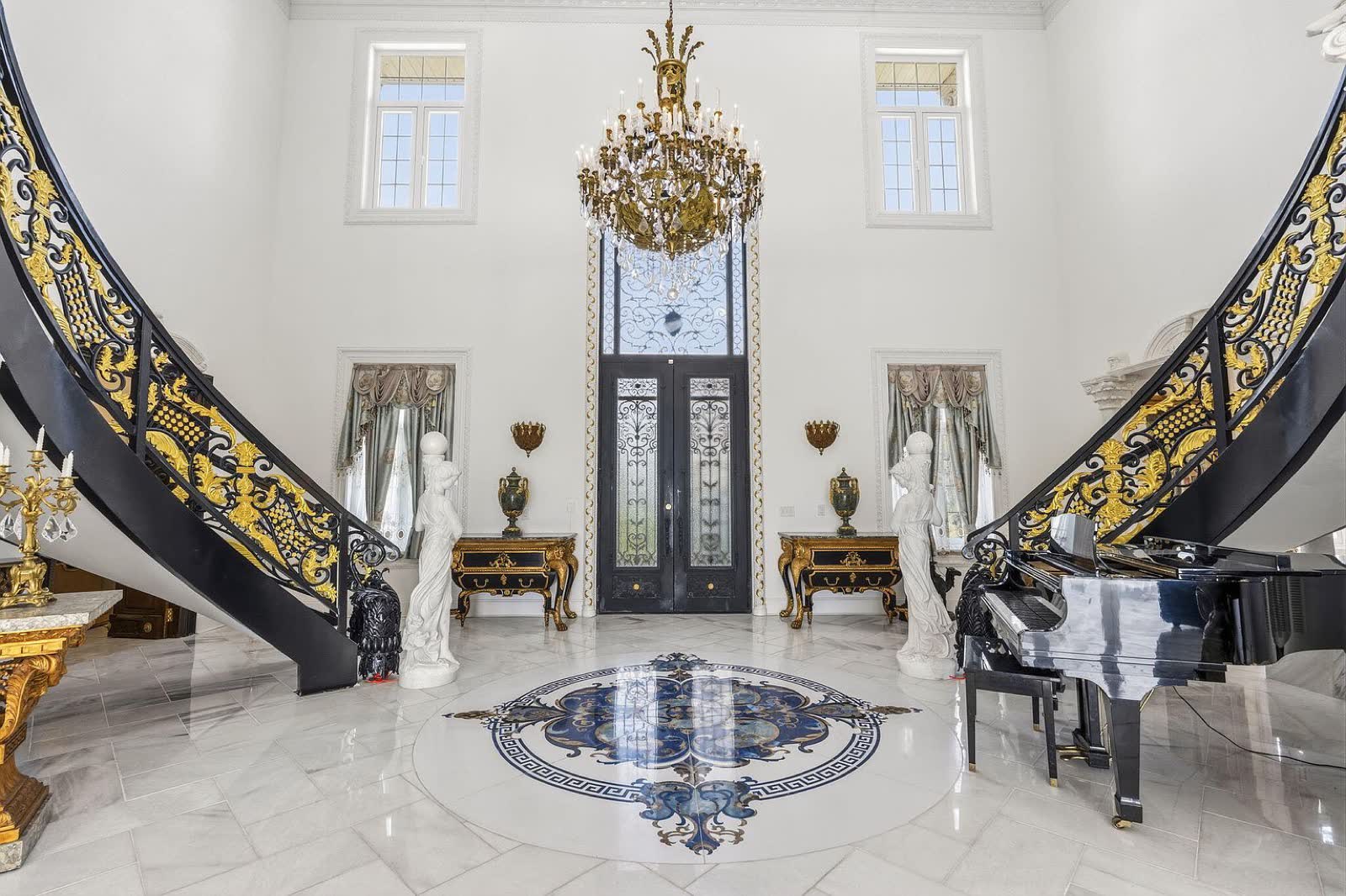Foyer with twin gilded staircases